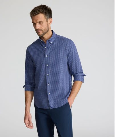 Model is wearing UNTUCKit Wrinkle-Free Solay Shirt in Navy Check. 