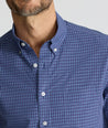 Model is wearing UNTUCKit Wrinkle-Free Solay Shirt in Navy Check. 