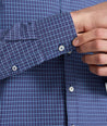 Model is wearing UNTUCKit Wrinkle-Free Solay Shirt in Navy Check. 