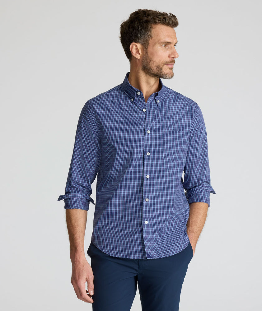 Model is wearing UNTUCKit Wrinkle-Free Solay Shirt in Navy Check. 
