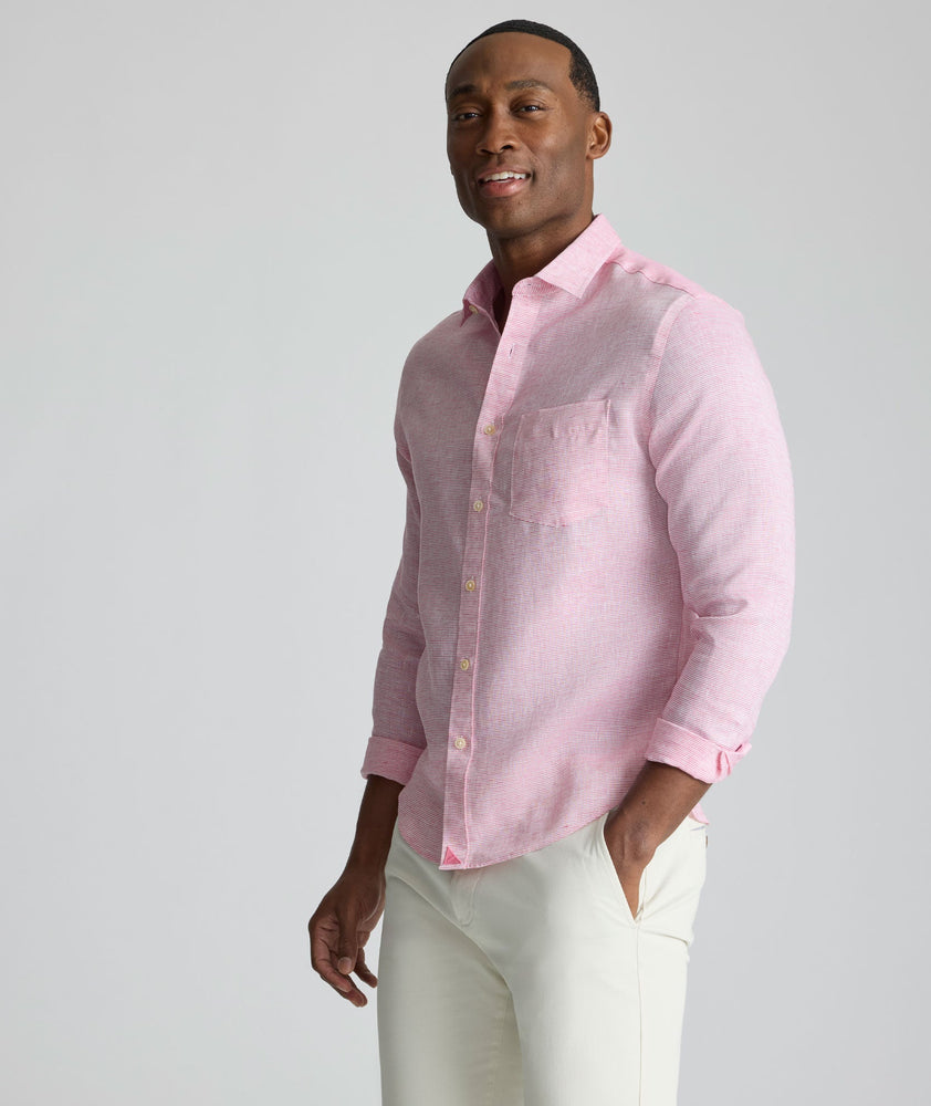 Model is wearing UNTUCKit Wrinkle-Resistant Linen Wildehart Shirt in pink. 