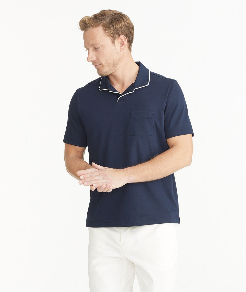 Model is wearing UNTUCKit Navy Tipped Johnny Collar Polo.