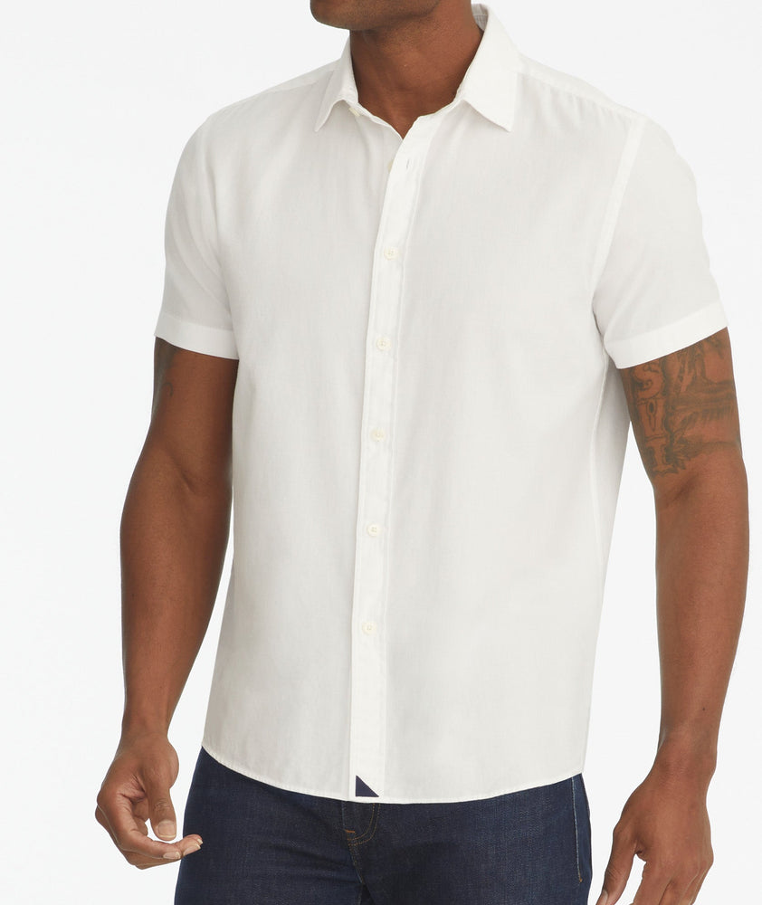 Model is wearing UNTUCkit white Briscoe short-sleeve button down.