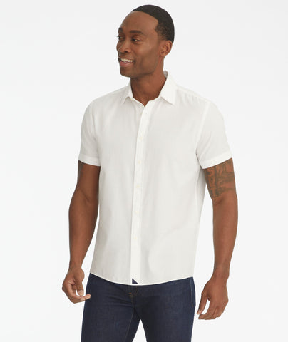 Model is wearing UNTUCkit white Briscoe short-sleeve button down.
