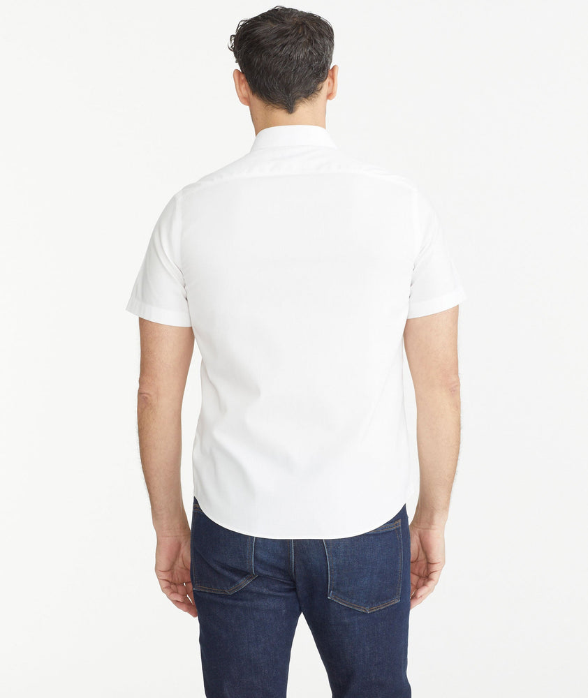 Model is wearing UNTUCKit White Wrinkle-Free Short-Sleeve Las Cases Shirt