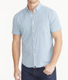 Model is wearing UNTCKit Navy Check Wrinkle-Free Performance Short-Sleeve Matarazzo Shirt