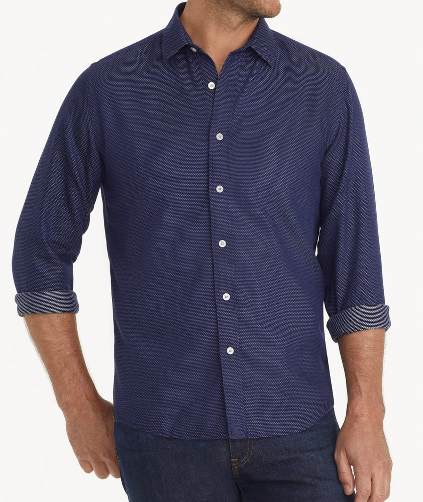 Model is wearing UNTUCKit Wrinkle-Free Milo Shirt in Navy & White Print